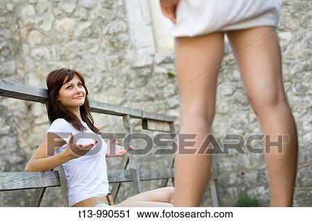 Two young women are talking View Large Photo Image Stock Image - Two young women are talking. Fotosearch