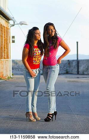 Stock Photo - Two young women are watching sunset. Fotosearch