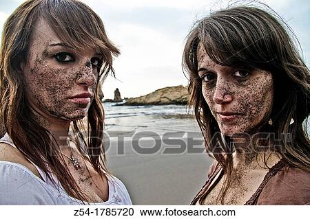 Two young women at El Sabl? n beach, with sand on their face, Asturias, Spain View Large Photo Image Stock Image - Two young women at El Sabl? n beach, with sand on their face, Asturias, Spain. Fotosearch