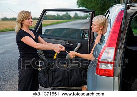 Two Young Women Holding Nylon Sport Travel Bag by Car View Large Photo Image Stock Image - Two Young Women Holding Nylon Sport Travel Bag by Car. Fotosearch