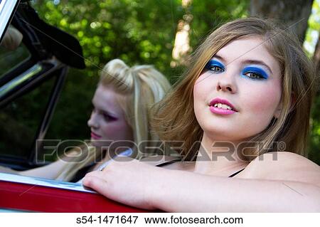 Two young women in a 1964 Dodge Dart in 1980s makeup. View Large Photo Image Stock Photo - Two young women in a 1964 Dodge Dart in 1980s makeup.. Fotosearch