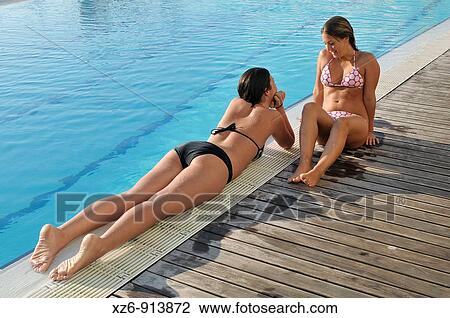 two young women in the swimming pool View Large Photo Image Stock Image - two young women in the swimming pool. Fotosearch