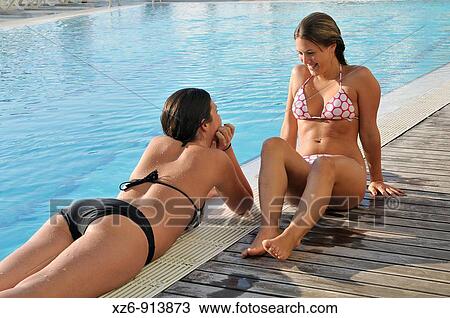 Stock Image - two young women in the swimming pool. Fotosearch