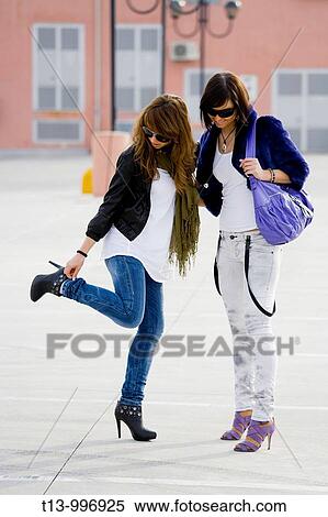 Two young women on the street View Large Photo Image Stock Photography - Two young women on the street. Fotosearch