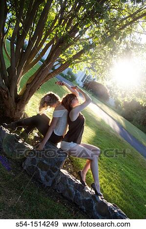 Two young women outdoors View Large Photo Image Stock Photo - Two young women outdoors. Fotosearch
