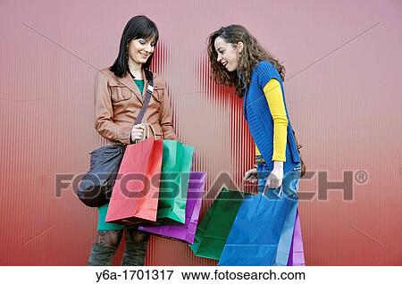 Two young women outdoors with shopping bags View Large Photo Image Stock Photo - Two young women outdoors with shopping bags. Fotosearch