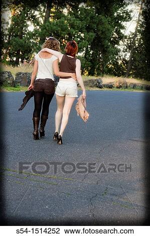 Two young women walking together in Spokane, Washington, USA. View Large Photo Image Stock Image - Two young women walking together in Spokane, Washington, USA.. Fotosearch