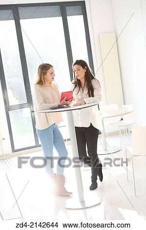 Two young women with digital tablet View Large Photo Image Picture - Two young women with digital tablet. Fotosearch