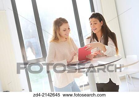 Two young women with digital tablet View Large Photo Image Stock Photography - Two young women with digital tablet. Fotosearch