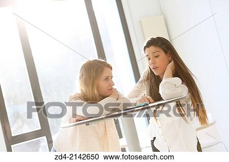 Two young women with smartphones View Large Photo Image Stock Image - Two young women with smartphones. Fotosearch