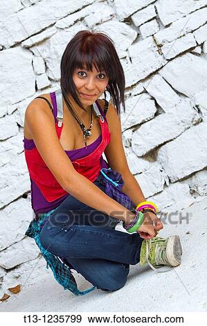 Stock Photo - Tying sneaker laces. Fotosearch