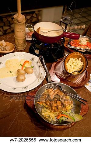 Typical dinner Swiss with cheese fondue, Raclette, Alpen Macaroni and rosti. Interlaken, Canton of Bern, Switzerland, Europe. View Large Photo Image Stock Photography - Typical dinner Swiss with cheese fondue, Raclette, Alpen Macaroni and rosti. Interlaken, Canton of Bern, Switzerland, Europe.. Fotosearch