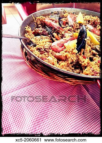 Typical Paella on red and white tablecloth View Large Photo Image Stock Image - Typical Paella on red and white tablecloth. Fotosearch