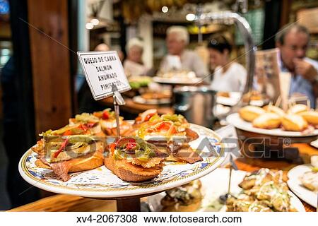 Typical Pintxos, also called tapas at popular San Sebastian bar, Basque Country, Spain. View Large Photo Image Stock Photo - Typical Pintxos, also called tapas at popular San Sebastian bar, Basque Country, Spain.. Fotosearch