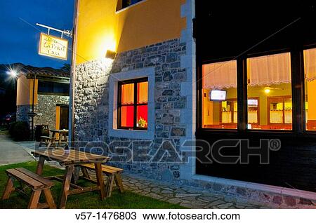 Stock Image - Typical restaurant, night view. Porra, Asturias province, Spain.. Fotosearch