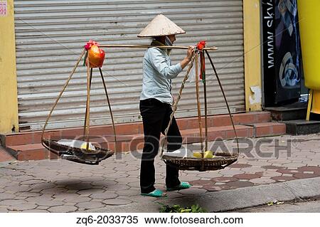 Stock Photography - Typical Street Vendor in the Streets of Hanoi, Vietnam.. Fotosearch