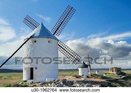 Typical windmill and castle in Consuegra village, in the Route of Don Qiuijote, Toledo province, Castilla-La Mancha, Spain. View Large Photo Image Picture - Typical windmill and castle in Consuegra village, in the Route of Don Qiuijote, Toledo province, Castilla-La Mancha, Spain.. Fotosearch
