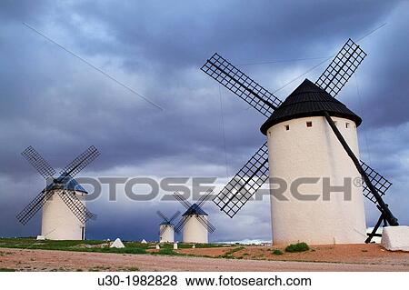 Stock Photo - Typical windmills at sunset in Campo de Criptana village, in the Route of Don Quiijote, Ciudad Real province, Castilla-La Mancha, Spain.. Fotosearch