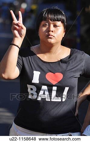 Ubud (Bali, Indonesia): a woman making the V sign View Large Photo Image Stock Photo - Ubud (Bali, Indonesia): a woman making the V sign. Fotosearch