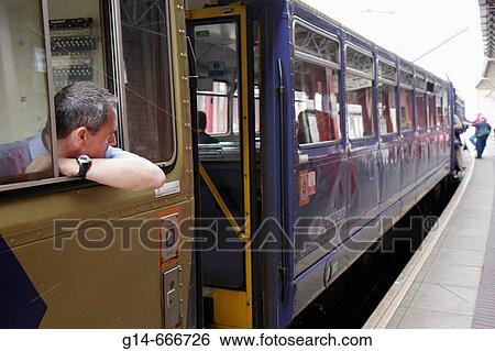 UK, England, Lancashire, Manchester, Deansgate Station, railway, train engineer, watches boarding passengers, View Large Photo Image Stock Photograph - UK, England, Lancashire, Manchester, Deansgate Station, railway, train engineer, watches boarding passengers,. Fotosearch