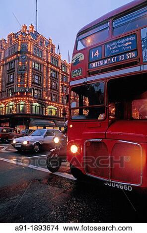 UK, England, London, Knightsbridge, Red double-decker bus passing by Harrods department store at dusk View Large Photo Image Picture - UK, England, London, Knightsbridge, Red double-decker bus passing by Harrods department store at dusk. Fotosearch