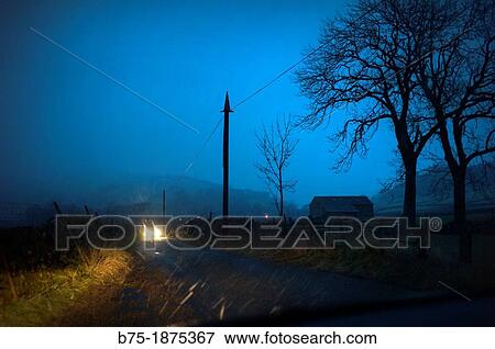 UK, England, North Yorkshire, Yorkshire Dales, country road, car headlights View Large Photo Image Stock Photo - UK, England, North Yorkshire, Yorkshire Dales, country road, car headlights. Fotosearch