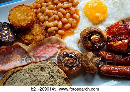Stock Photography - UK. Food. Typical english breakfast: beans, sausages, bacon,, eggs, etc.. Fotosearch