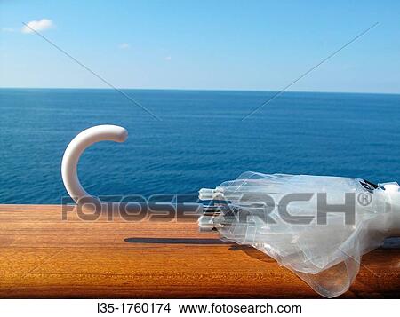 Umbrella on the rail, cruise, mediterranean. View Large Photo Image Picture - Umbrella on the rail, cruise, mediterranean.. Fotosearch