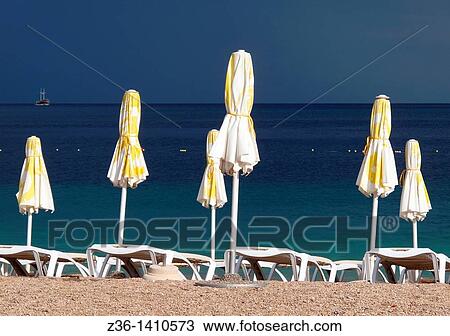 Stock Image - Umbrellas at Croatia's most famous beach The Golden Horn Zlatni Rat near Bol on the Island of Brac, Croatia. Fotosearch