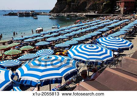 Stock Image - Umbrellas on the Beach in the Old Town at Monterosso al Mare Cinque Terre Liguria Italy.. Fotosearch