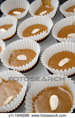 uncooked honey & spice cupcakes with flaked almond topping. View Large Photo Image Stock Photo - uncooked honey & spice cupcakes with flaked almond topping.. Fotosearch