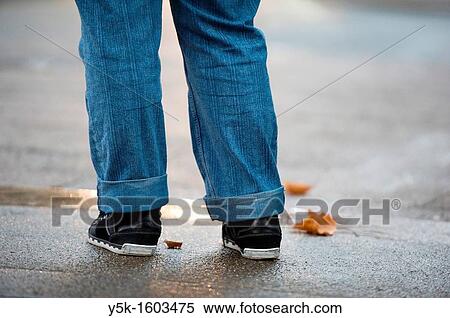 Under-legs of a young woman, with feet, jeans and shoes, standing on the pavement, just before crossing a street in Rotterdam, Netherlands View Large Photo Image Stock Photography - Under-legs of a young woman, with feet, jeans and shoes, standing on the pavement, just before crossing a street in Rotterdam, Netherlands. Fotosearch