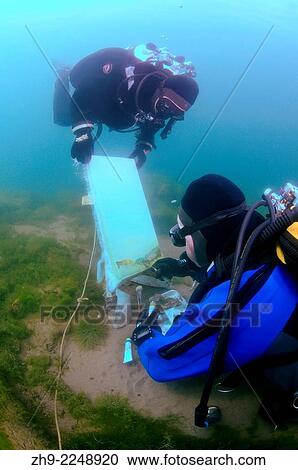 Stock Image - Underwater artist Yuriy Alexeev (Yuri Alekseev) paints a picture under water. Lake Baikal, Listvyanka, Irkutsky District, Irkutsk Oblast, Siberia, Russia, Eurasia.. Fotosearch