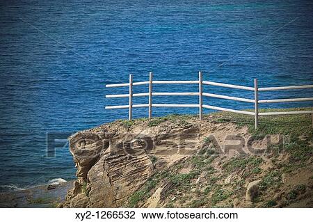 Unfinished fence on cliff above ocean View Large Photo Image Stock Image - Unfinished fence on cliff above ocean. Fotosearch