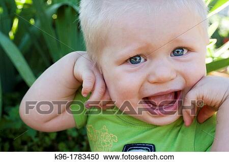 Stock Image - unhappy baby boy. Fotosearch