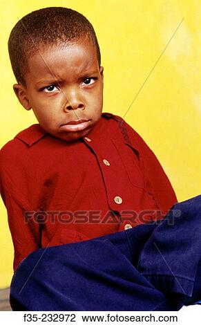Stock Image - Unhappy Young boy in Red Shirt. Fotosearch