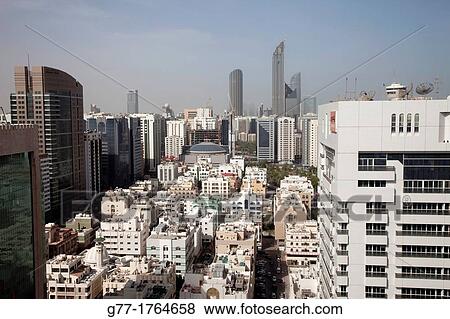 United Arab Emirates Abu Dhabi. Old houses and modern buildings. View Large Photo Image Stock Photo - United Arab Emirates Abu Dhabi. Old houses and modern buildings.. Fotosearch
