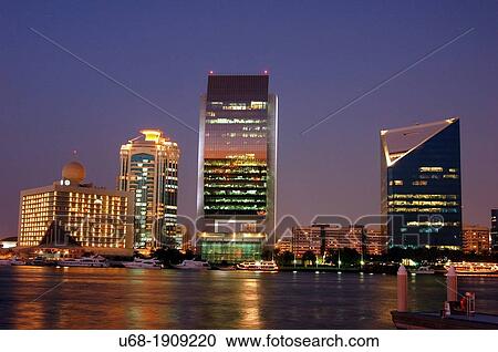 Stock Image - United Arab Emirates, Dubai, Dubai Creek. In the background Deira Creek neighborhood and The tower of the Chamber of Commerce and Industry and the headquarters of the National Bank of Dubai.. Fotosearch
