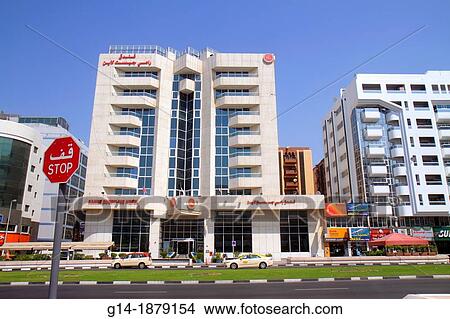 Picture - United Arab Emirates, U A E, UAE, Middle East, Dubai, Deira, Al Rigga, Al Rigga Road, street scene, buildings, businesses, stop sign, English, Arabic, language,. Fotosearch