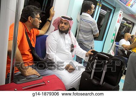 United Arab Emirates, U A E, UAE, Middle East, Dubai, Deira, Al Rigga Metro Station, Red Line, subway, public transportation, inside, cabin, Asian, man, riders, passengers, Middle Eastern, Muslim, Bedouin, thawb, keffiyeh, luggage, View Large Photo Image Stock Photograph - United Arab Emirates, U A E, UAE, Middle East, Dubai, Deira, Al Rigga Metro Station, Red Line, subway, public transportation, inside, cabin, Asian, man, riders, passengers, Middle Eastern, Muslim, Bedouin, thawb, keffiyeh, luggage,. Fotosearch
