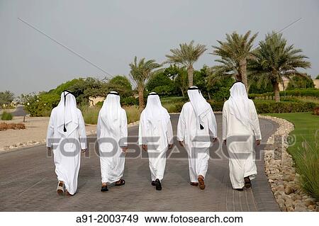 Stock Photo - United Arab Emirates (UAE), Abu Dhabi, Sir Bani Yas island, five bearded men in white kandoura dishdash. Fotosearch