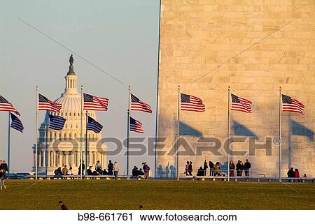 United States, Washington, District of Columbia, US Capitol Building with flags at the Washington Monument and tourists. View Large Photo Image Stock Image - United States, Washington, District of Columbia, US Capitol Building with flags at the Washington Monument and tourists.. Fotosearch