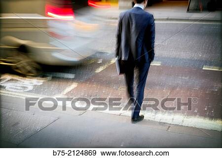 Unrecognizable executive with a portfolio trying to cross the street with trafic in London, England, UK, Europe View Large Photo Image Stock Photo - Unrecognizable executive with a portfolio trying to cross the street with trafic in London, England, UK, Europe. Fotosearch