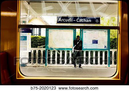 Unrecognizable man covering his face with his hand on the platform of the station Arcueil-Cachan, Paris, France View Large Photo Image Stock Image - Unrecognizable man covering his face with his hand on the platform of the station Arcueil-Cachan, Paris, France. Fotosearch