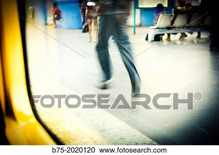 Unrecognizable man in motion, walking in a subway station in Paris, France View Large Photo Image Stock Image - Unrecognizable man in motion, walking in a subway station in Paris, France. Fotosearch