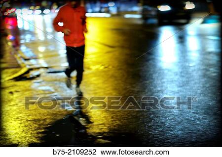 Unrecognizable man jogging down the street at night. London, England, UK, Europe View Large Photo Image Stock Image - Unrecognizable man jogging down the street at night. London, England, UK, Europe. Fotosearch