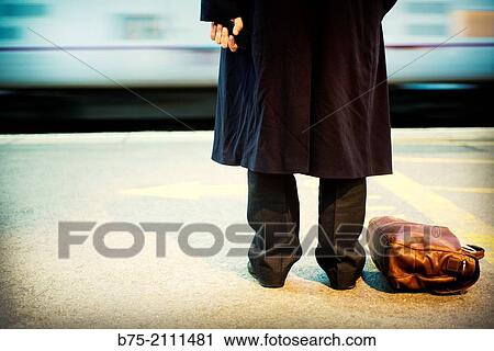 Unrecognizable man with a suitcase on the floor, waiting on the platform at the York train station. Yorkshire, England, UK, Europe. View Large Photo Image Stock Image - Unrecognizable man with a suitcase on the floor, waiting on the platform at the York train station. Yorkshire, England, UK, Europe.. Fotosearch
