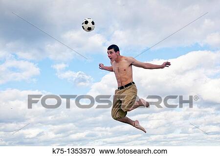 Up in the air hitting a soccer ball View Large Photo Image Stock Image - Up in the air hitting a soccer ball. Fotosearch
