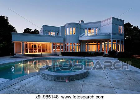 Upscale home at dusk with swimming pool View Large Photo Image Stock Photo - Upscale home at dusk with swimming pool. Fotosearch