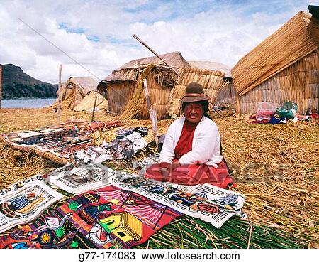 Stock Image - Uru indian woman selling textiles. Titicaca Lake. Peru. Fotosearch